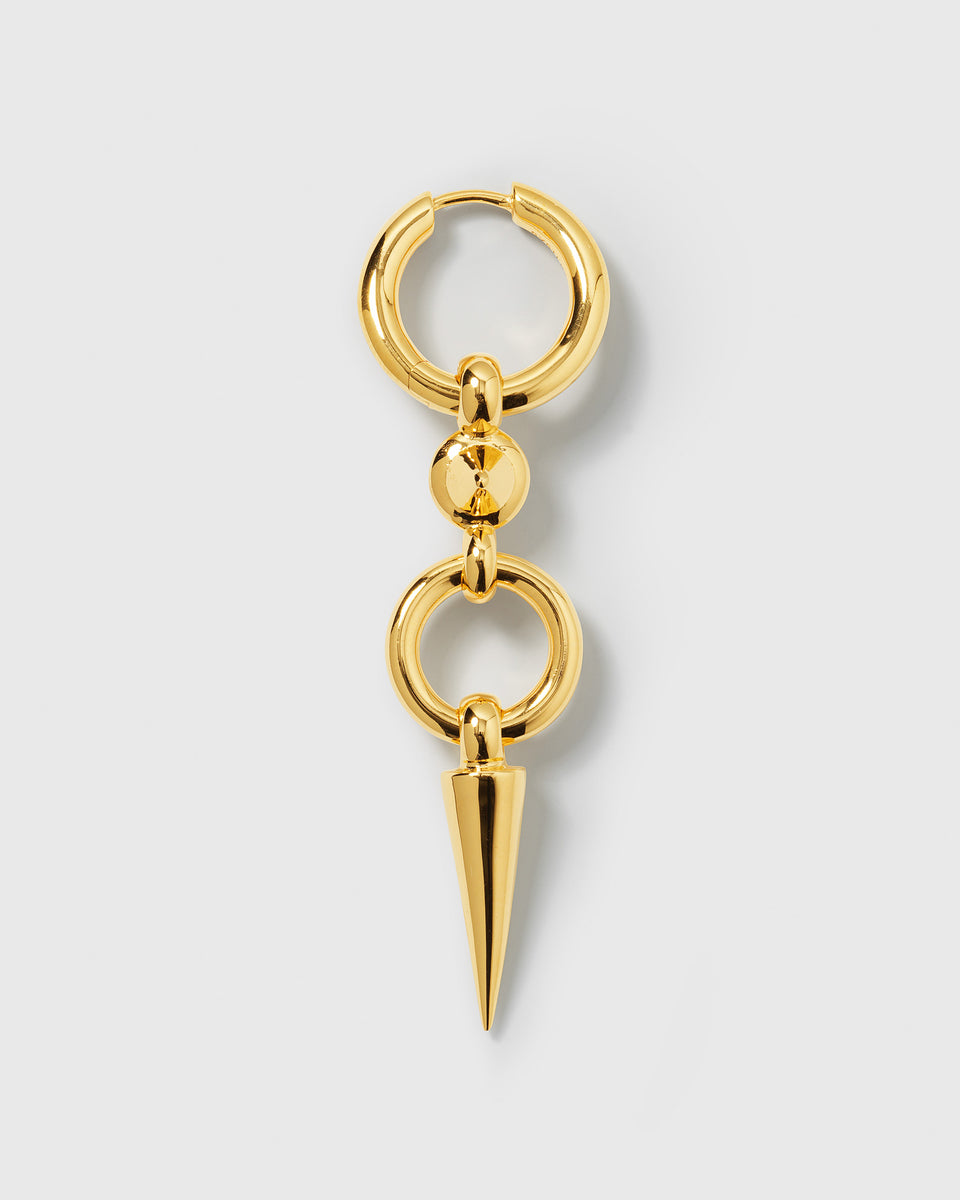 A product shot of the Juno Long Single Earring in gold, showcasing its chunky hoop design connected to a long, dangling spike pendant.