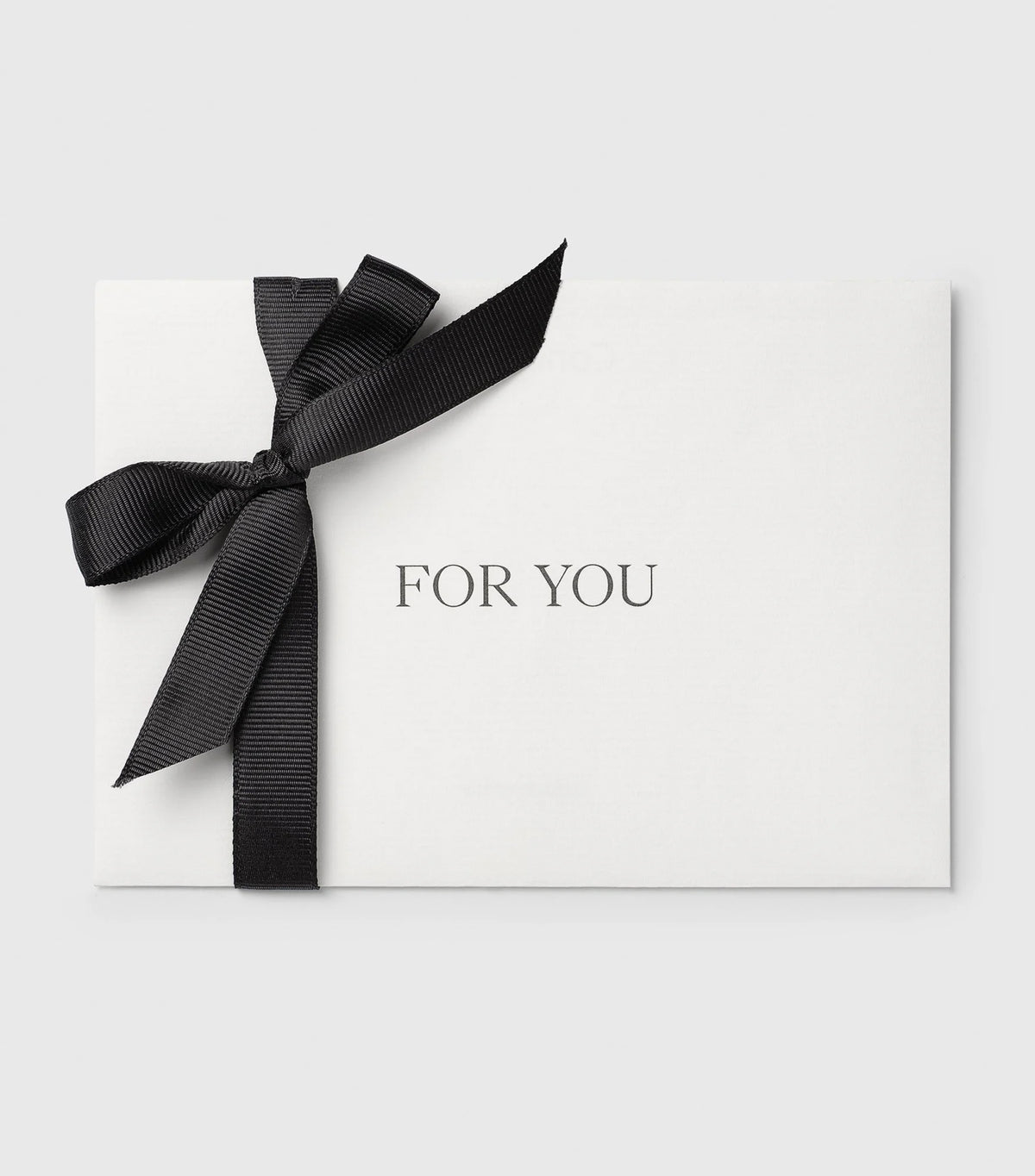 A Syster P gift card presented in a white envelope, elegantly tied with a black ribbon and featuring the words 'FOR YOU'.