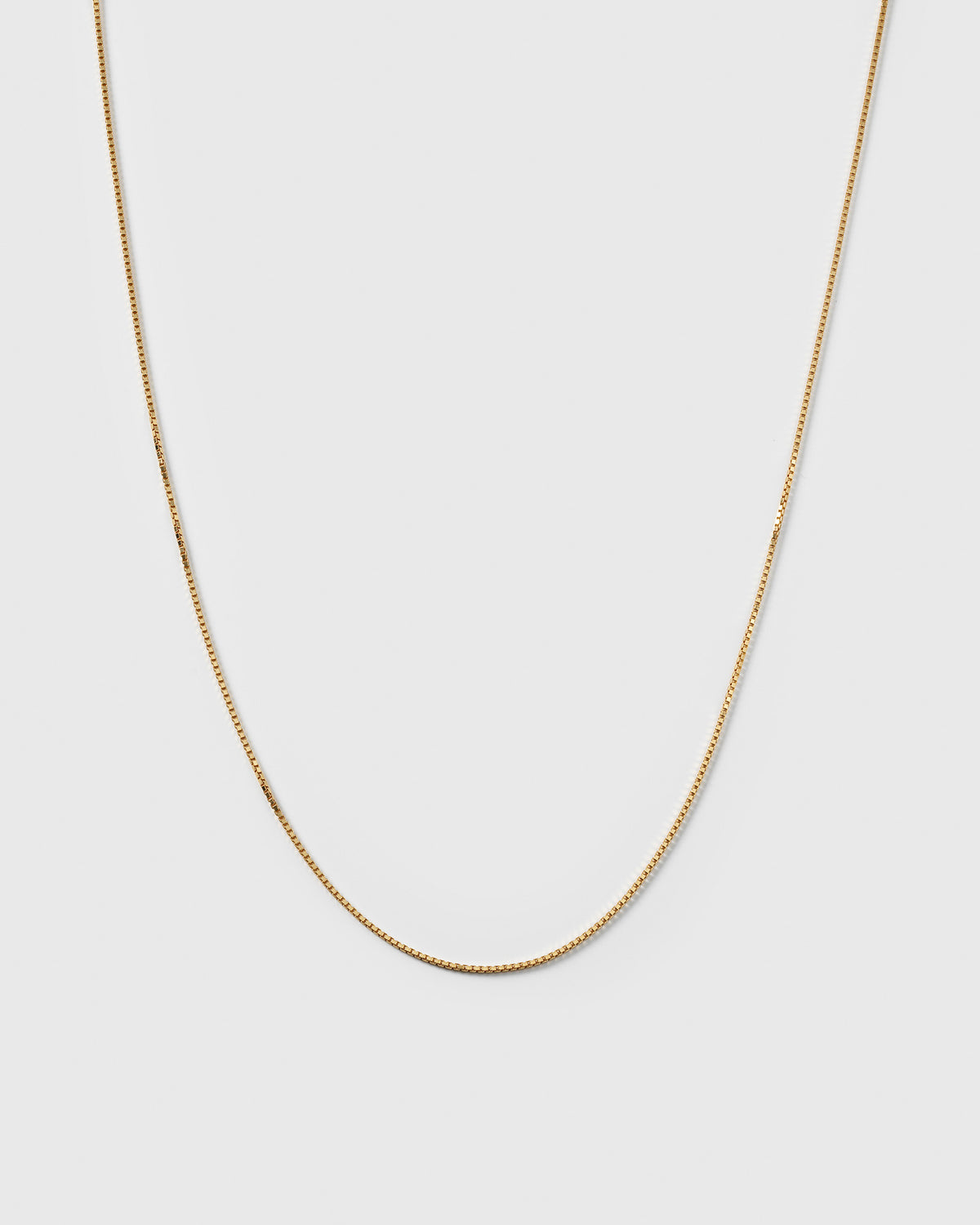 A product shot of the Beloved Medium Box Chain in gold, showcasing its delicate box link design.