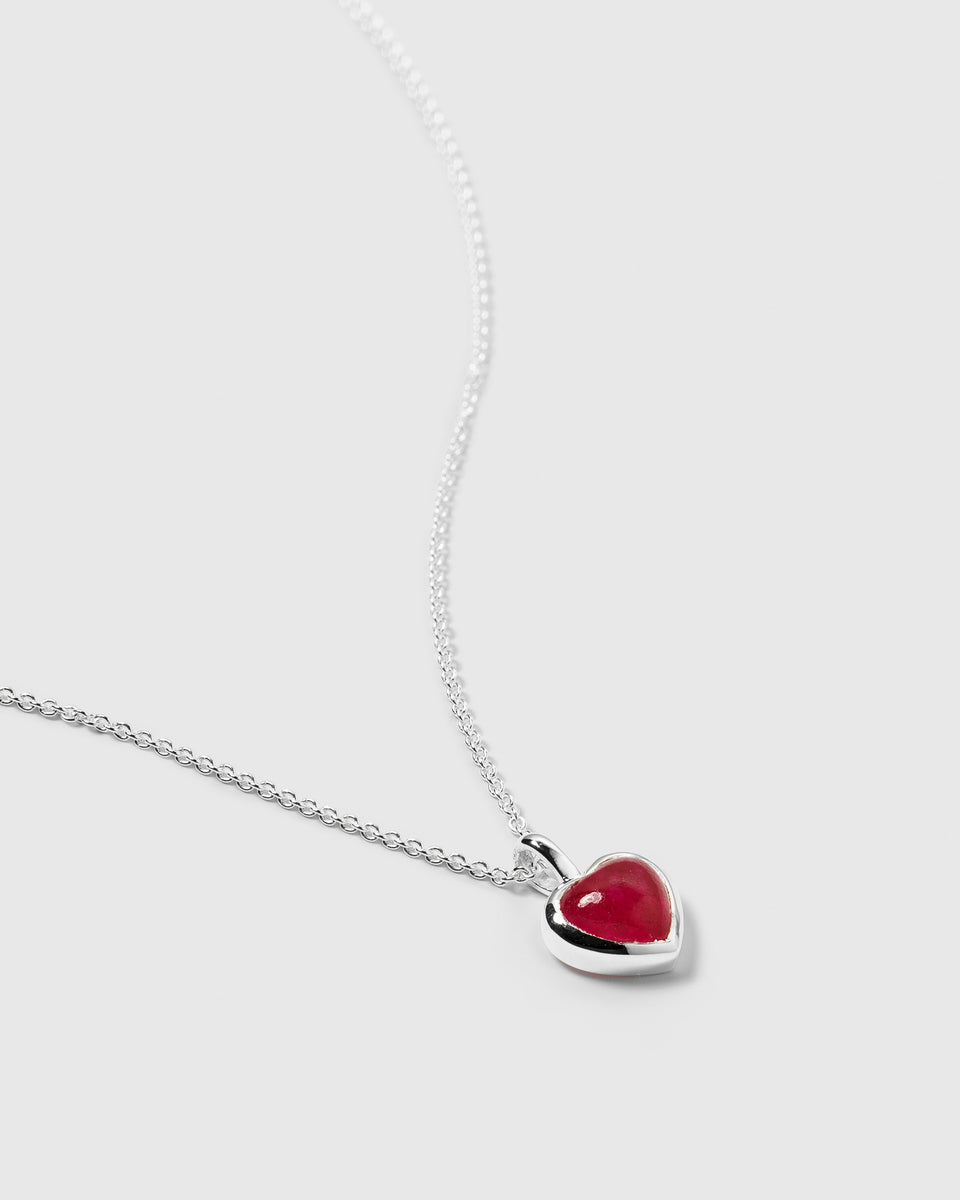 A detailed view of the La La Love Necklace in silver, with its delicate chain and a heart-shaped pink quartz pendant.