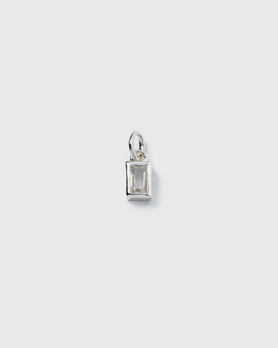 A product shot of the Beloved Squared Pendant in silver, featuring a rectangular clear crystal set in a simple, polished silver frame.