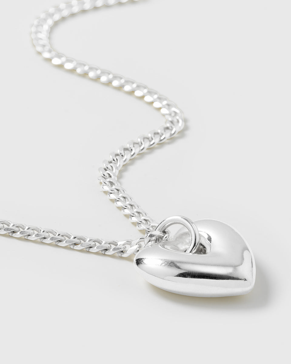 A close-up product shot of the RENTAL - Fat Heart Necklace in silver, featuring its chunky curb chain and large, puffy heart pendant.