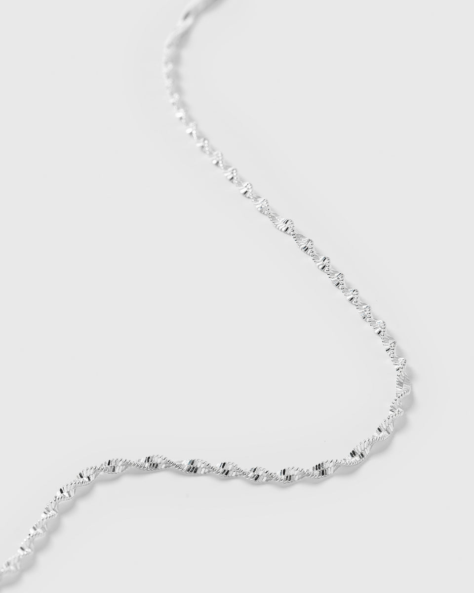 A close-up shot of the Herringbone Twisted Necklace in silver, highlighting the delicate and intricate twisted pattern of the chain.