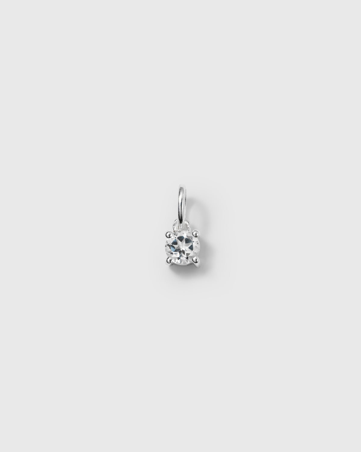 A product shot of the Beloved Solo Nova Pendant in silver, featuring a single round white topaz held in a four-prong setting.