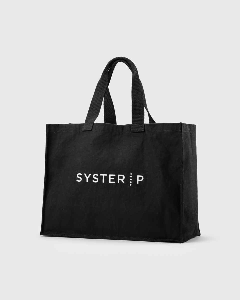 A product shot of the black Syster P Tote Bag, featuring the white brand logo printed on the front.