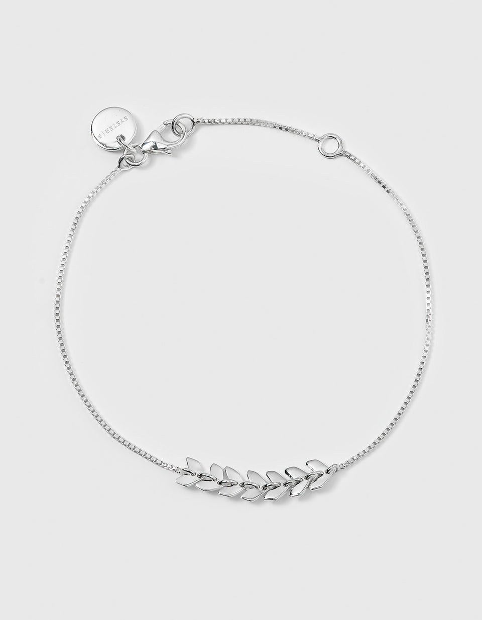 Studio shot of the Layers Simone Bracelet in silver, featuring a delicate chain with a central pattern formed by small, interconnected leaf-like links.
