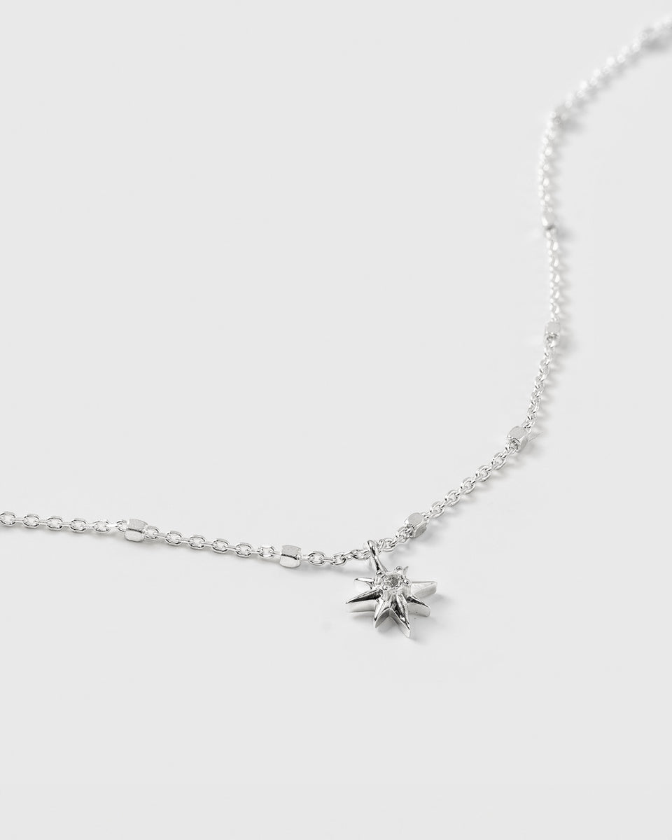 A close-up product shot of the North Star Bracelet in silver, showcasing its delicate chain and the North Star charm adorned with a small, faceted crystal.