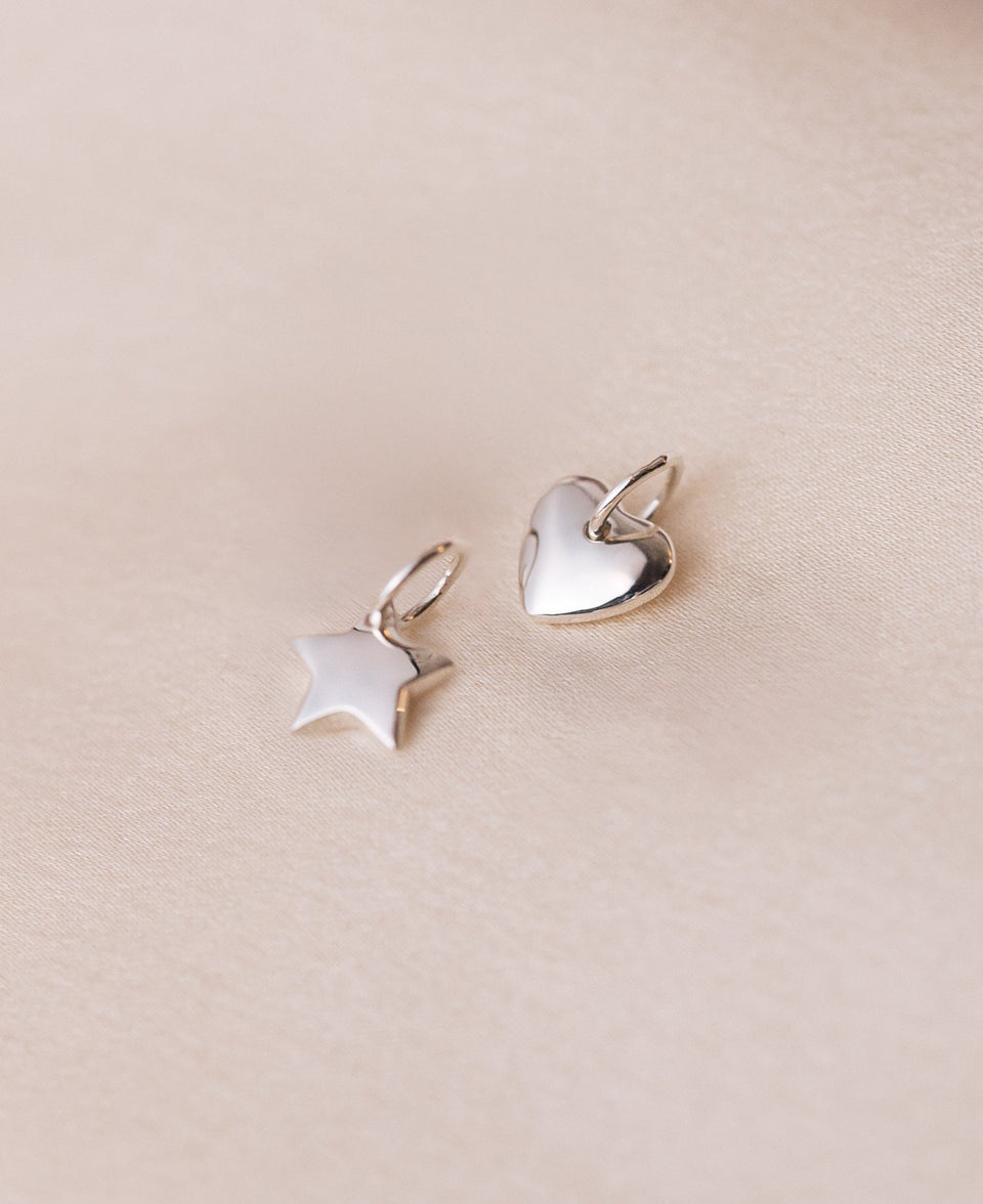 A product shot of the Beloved Star Pendant in silver, shown alongside the matching Beloved Heart Pendant.