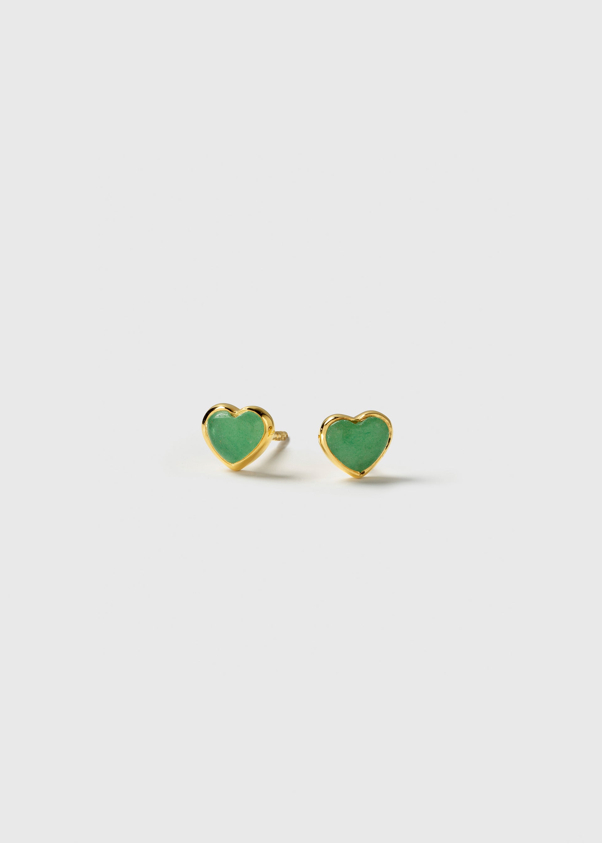 A pair of La La Love stud earrings, featuring heart-shaped green jade stones set in a polished gold-plated frame.