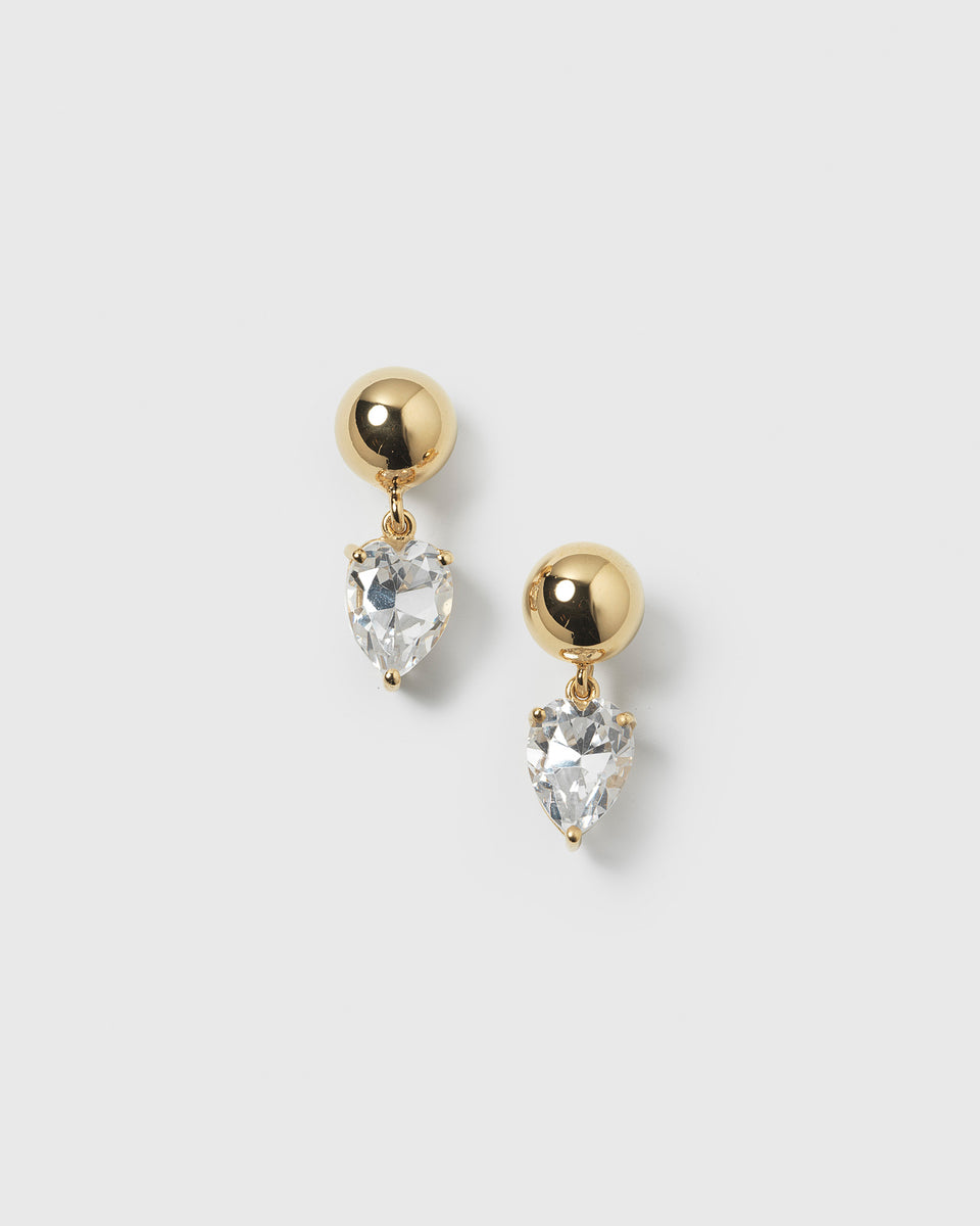 A product shot of the Katie Earrings in gold, featuring a round gold stud and a dangling drop-shaped cubic zirconia.