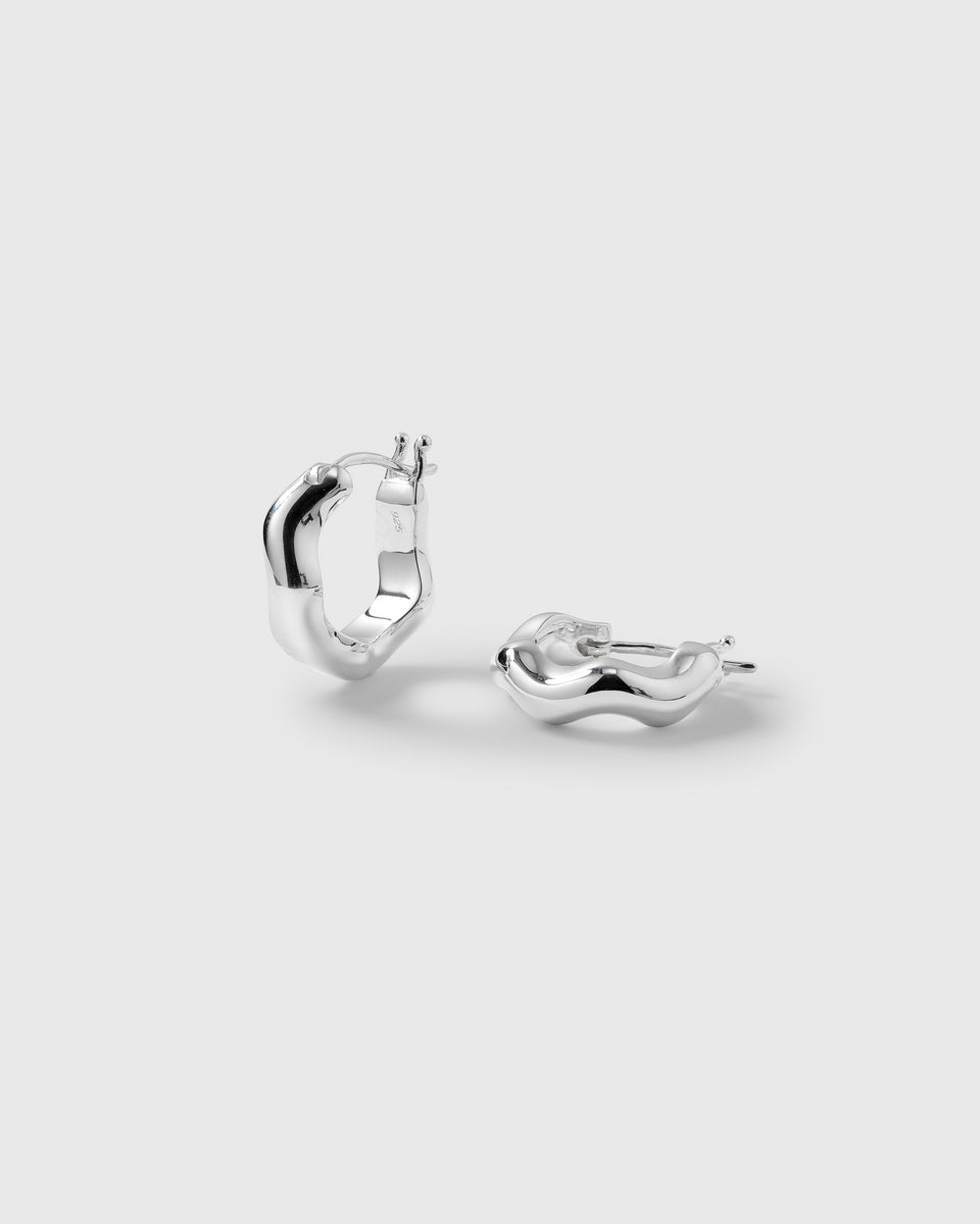 A product shot of the Bolded Wavy Earrings in silver, showcasing their chunky and fluid wavy design.