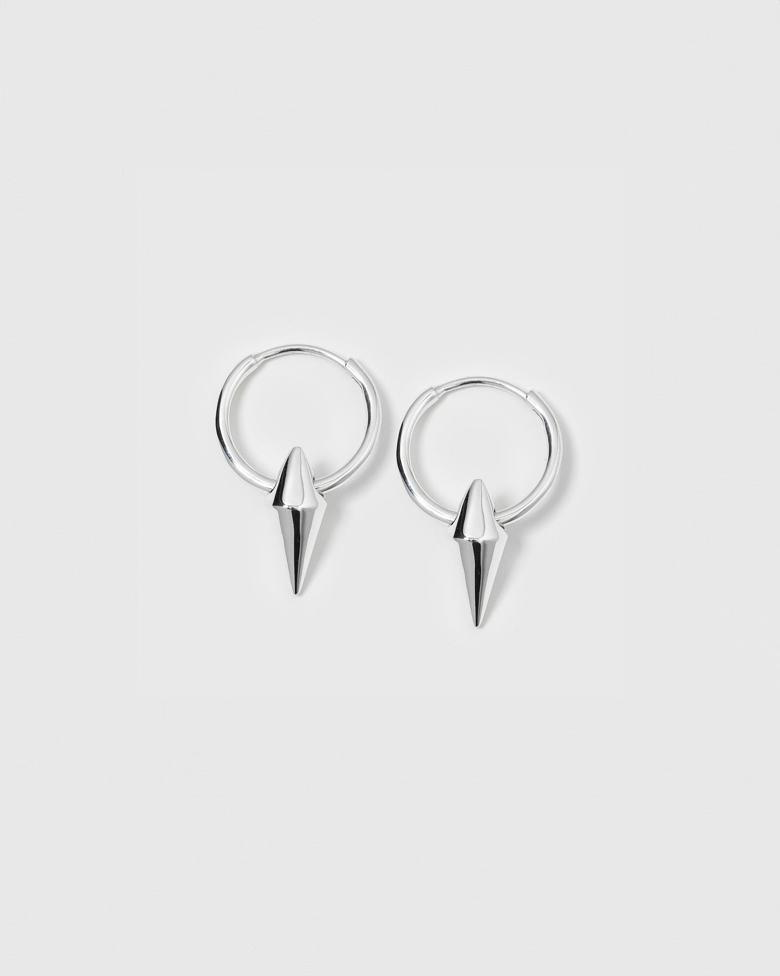 A product shot of the Harvey Small Spike Hoops in silver, showing the pair of small hoops with their pointed spike pendants.