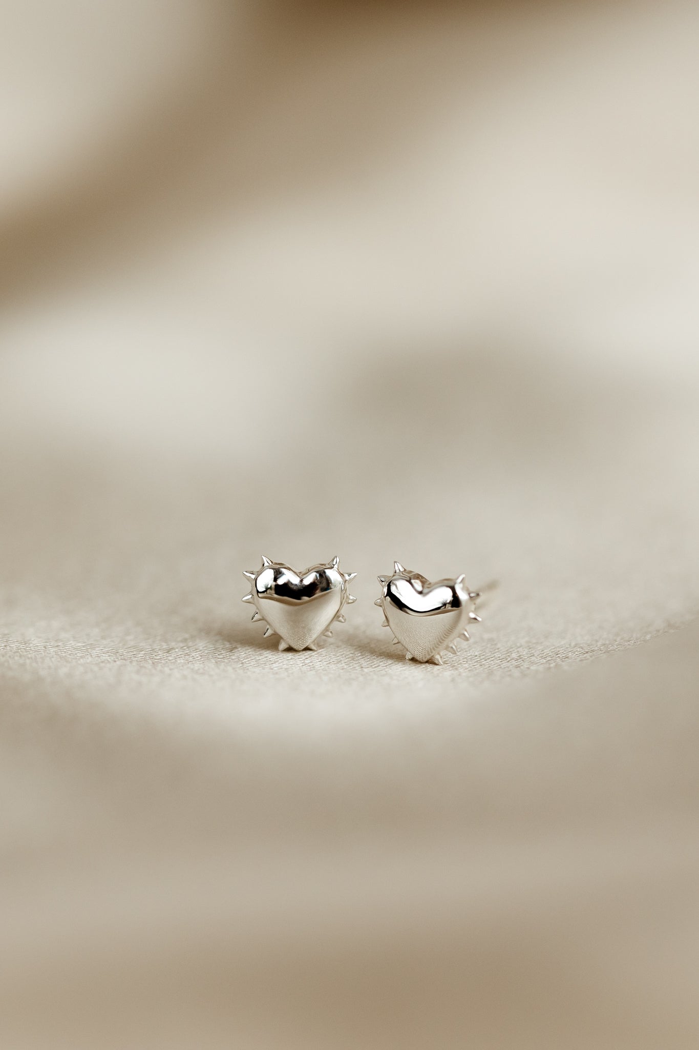 A close-up image of the silver True Love Spike Heart Studs, detailing their heart shape and the small spikes around the edges.