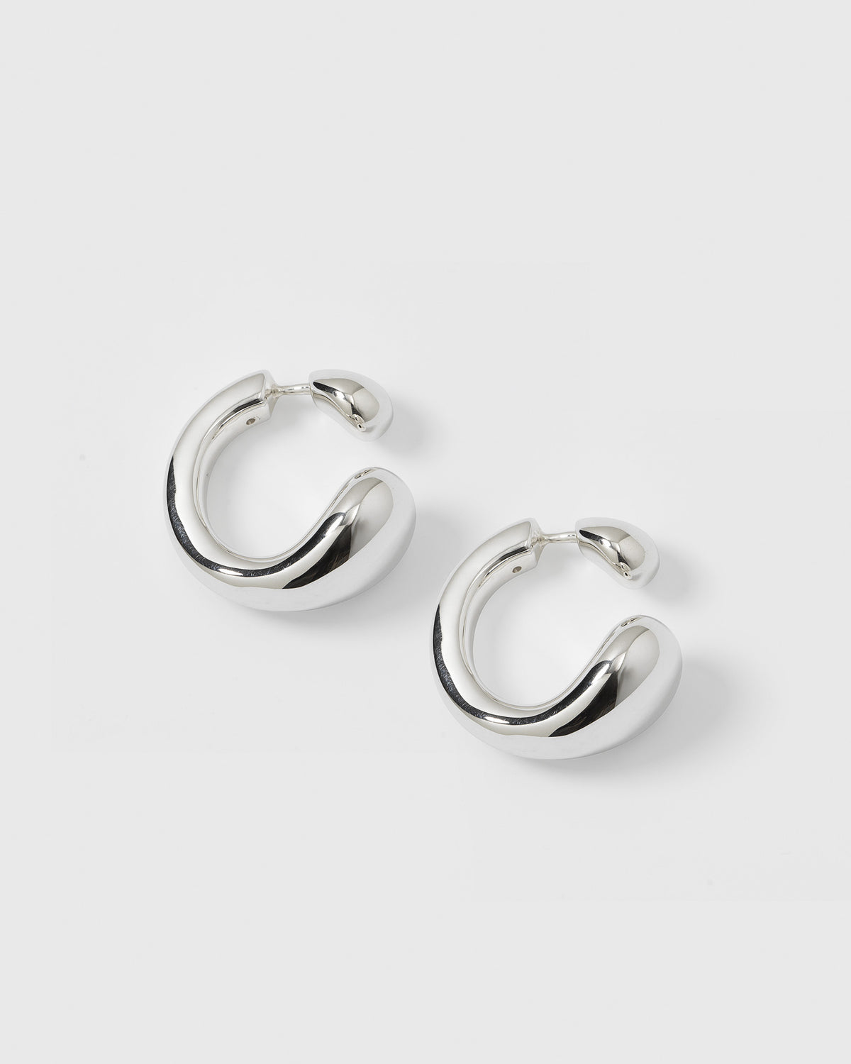 A product shot of the Bolded Drops Earrings in silver, showcasing their unique, bold, and drop-inspired shape.