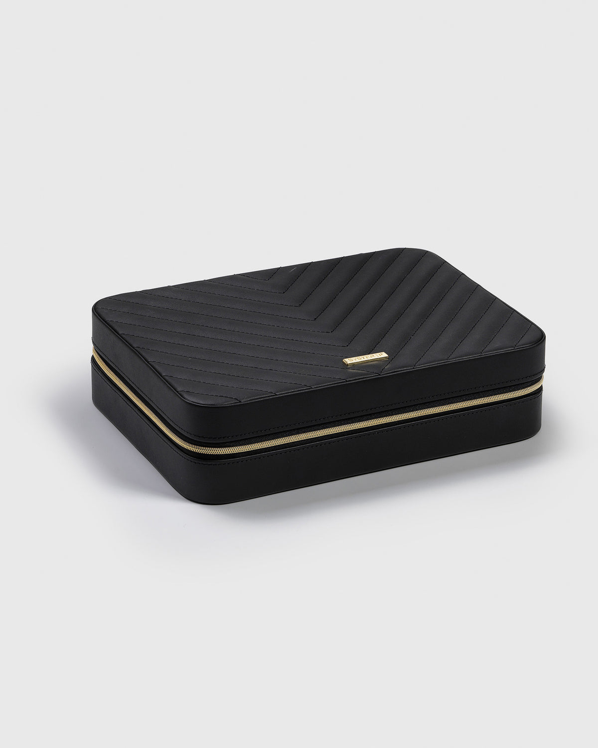 A product shot of the Jewelry Case Large in black, showcasing its chevron-stitched vegan leather exterior and gold-finished zipper and logo.
