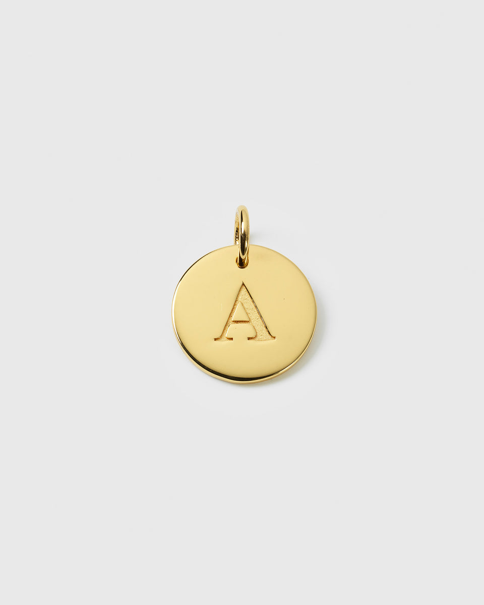 A product shot of the Beloved Big Letter Gold pendant, featuring a circular gold charm with the letter 'A' engraved on its surface.