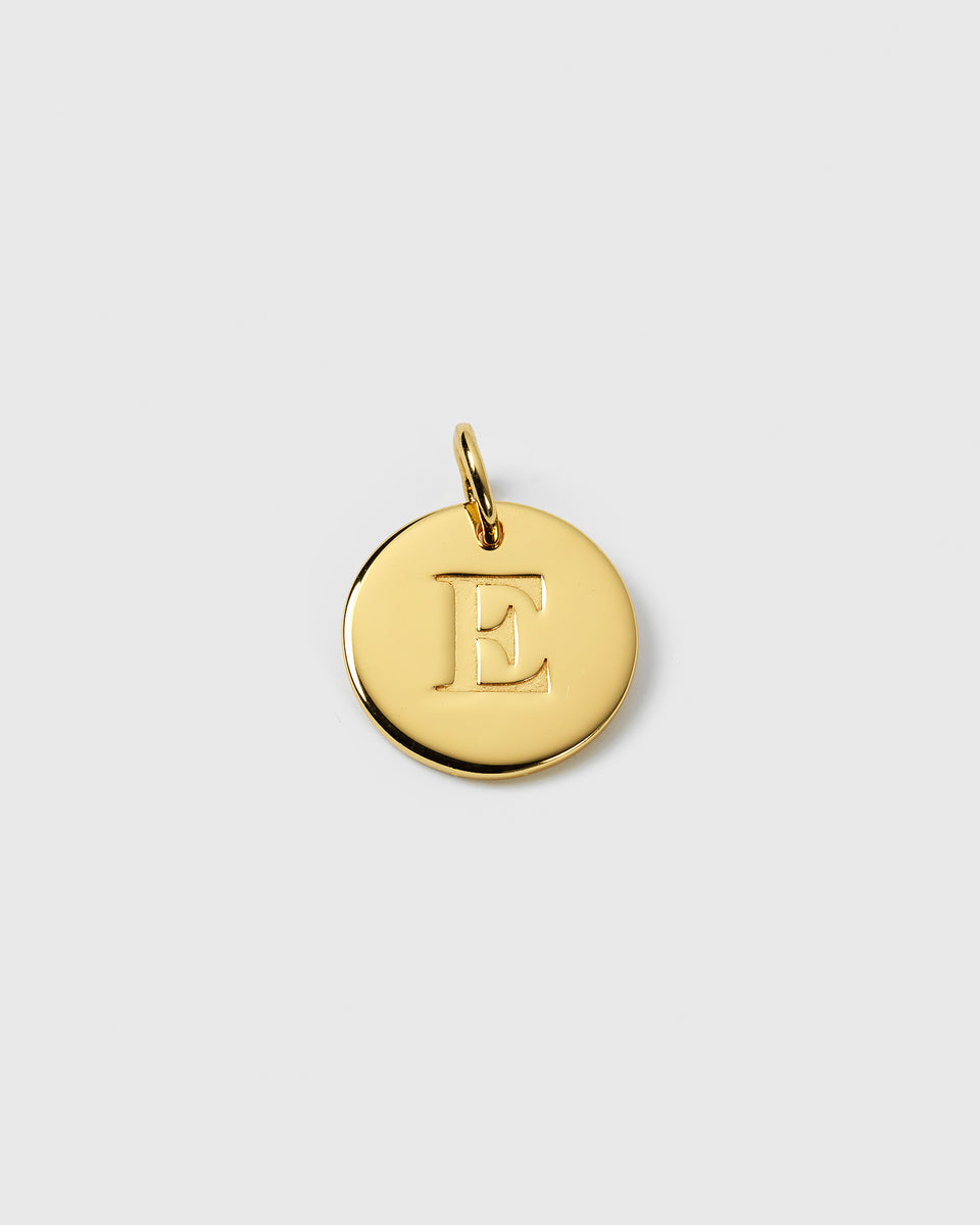 A product shot of the Beloved Big Letter Gold pendant, featuring a circular charm with the letter 'E' engraved on it.