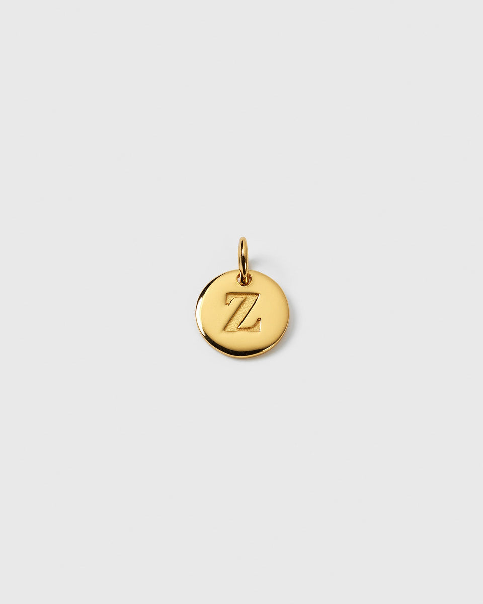 A product shot of the gold Beloved Mini Letter charm, showing the letter 'Z' engraved on the circular pendant.