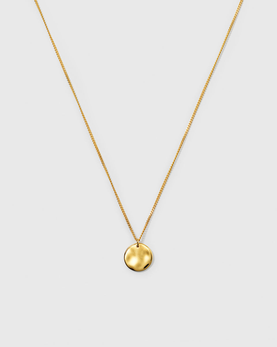 A product shot of the Minimalistica Hammered Circle Necklace in gold, showcasing its fine chain and round, hammered-finish pendant.