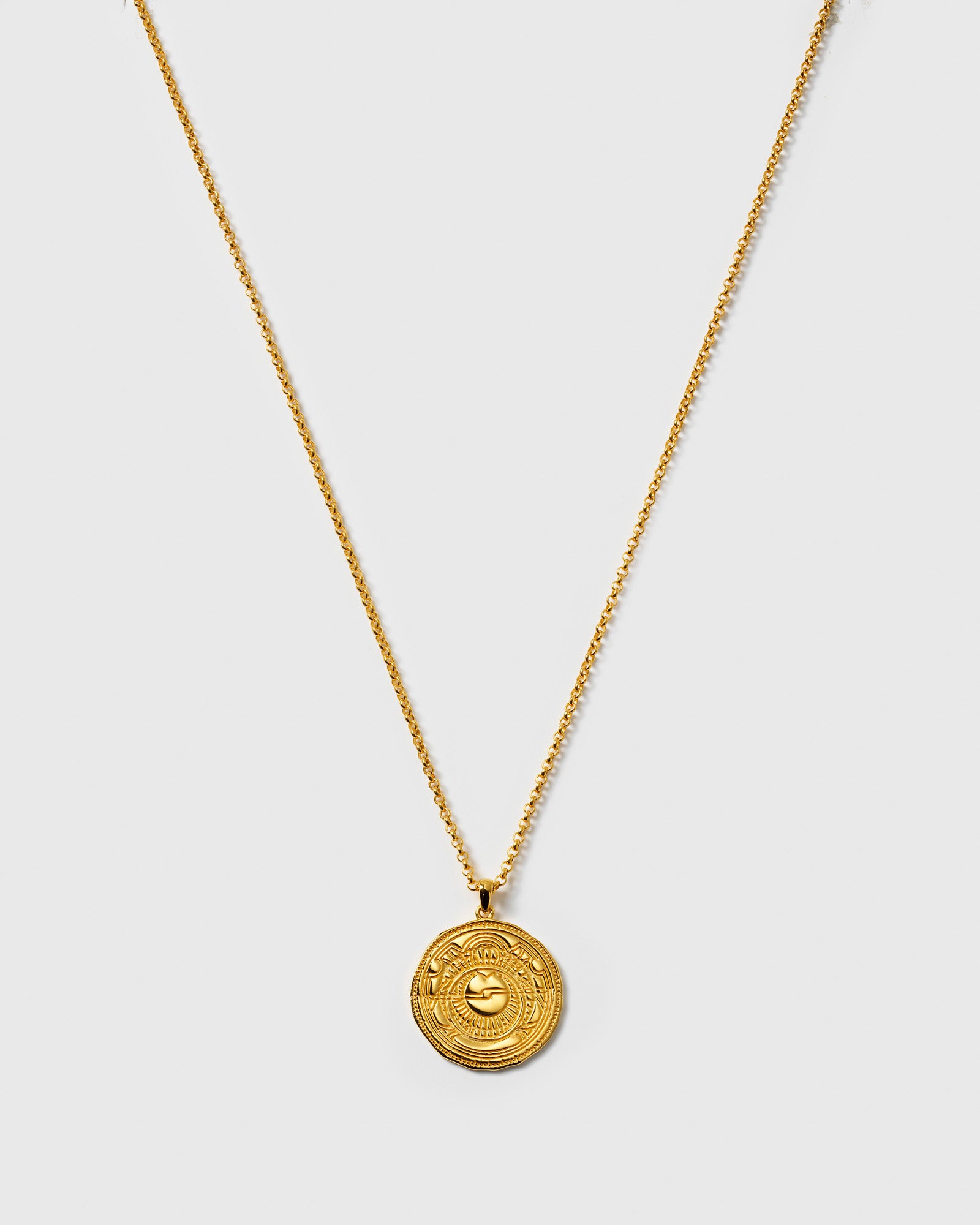 A product shot of the Lucky Coin Navigate Necklace in gold, featuring a fine chain and a round, coin-like pendant with an embossed compass design.