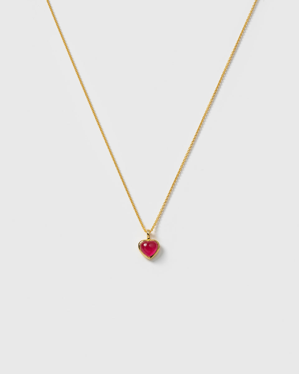 A product shot of the La La Love Necklace in gold, featuring a delicate chain and a heart-shaped pink quartz pendant.
