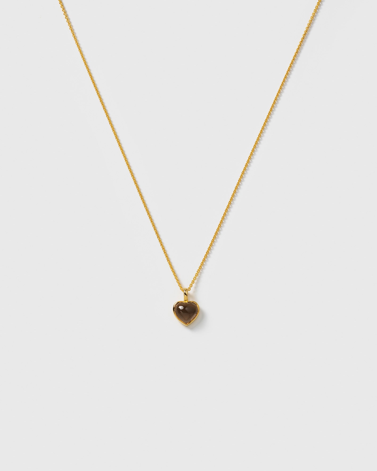 La La Love Necklace with a delicate gold chain and a heart-shaped pendant with a smokey quartz stone.