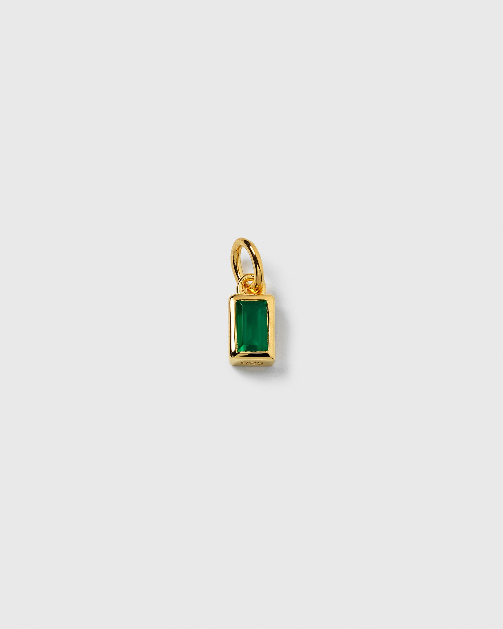 A product shot of the Beloved Squared Pendant in gold, showcasing its rectangular design with a vibrant green onyx stone.