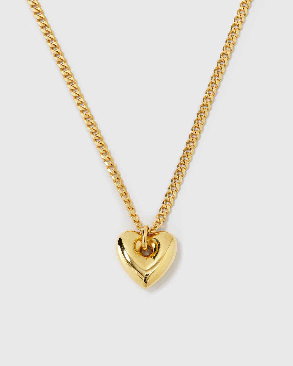 A product shot of the Fat Heart Necklace in gold, featuring a chunky curb chain and a large, puffy heart-shaped pendant.