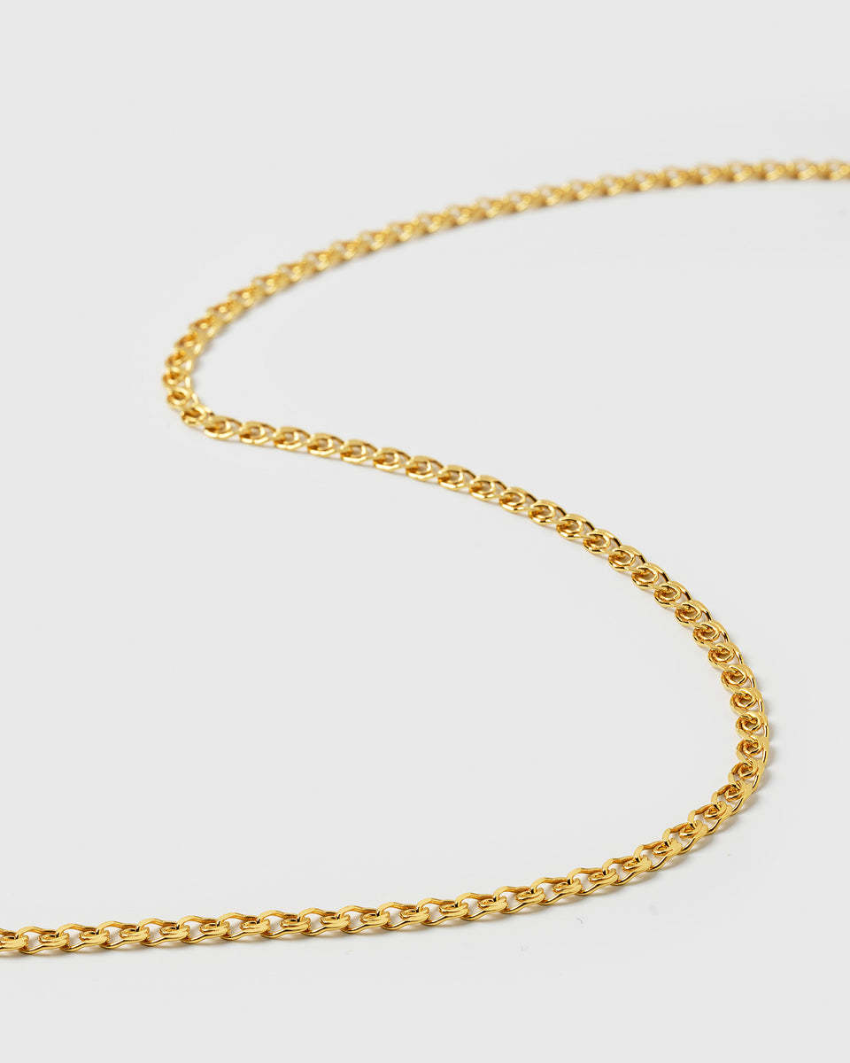 A close-up product shot of the Sheer Love Necklace in gold, highlighting the intricate patterned design of the chain.