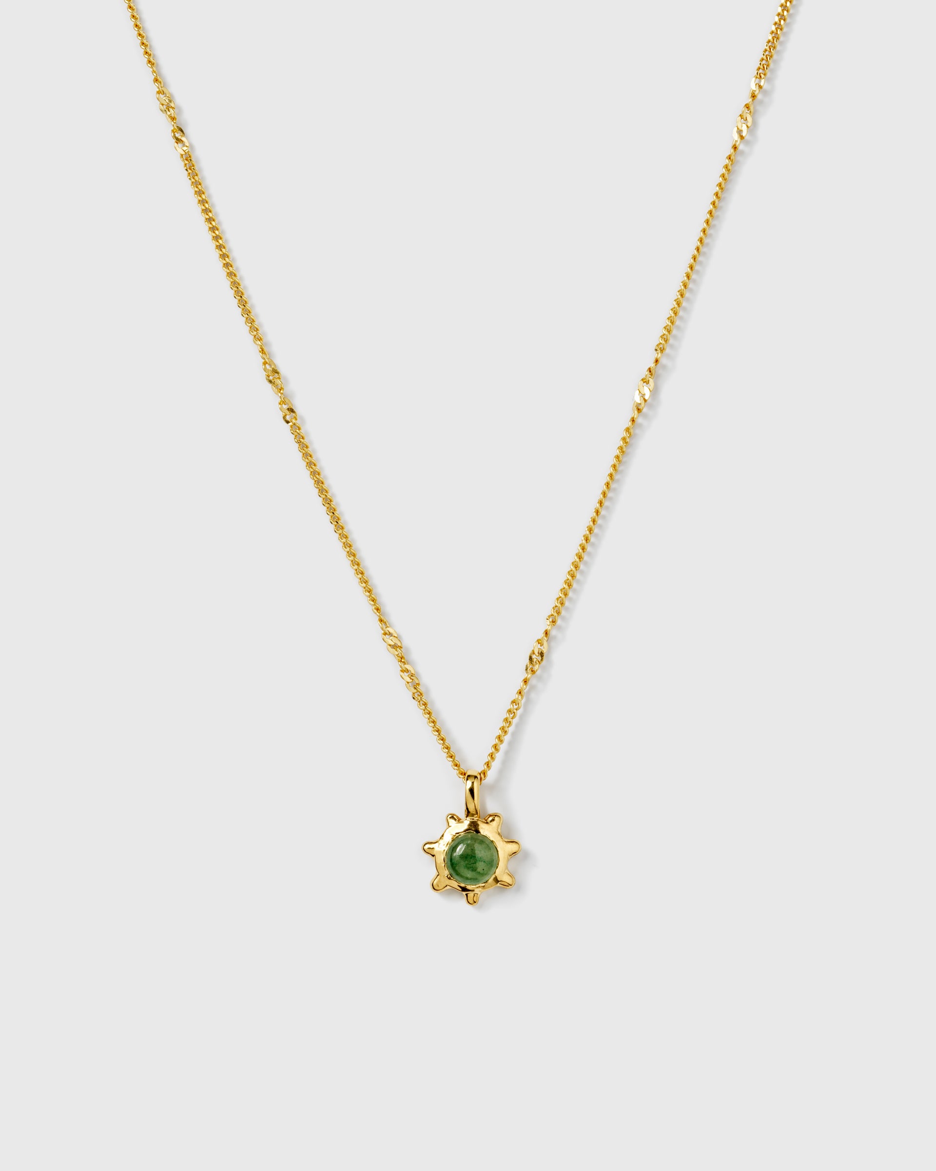 A product shot of the Florentina Necklace in gold, featuring a delicate twisted chain and a flower-shaped pendant with a green jade stone.