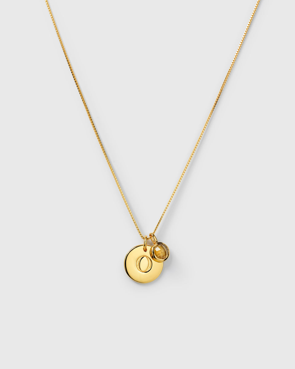 Gold chain with November birthstone citrine and letter pendant.