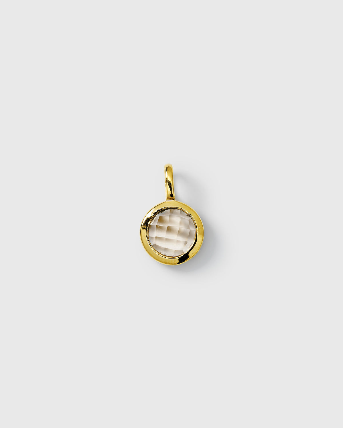 Gold pendant featuring a round faceted white topaz, April birthstone.