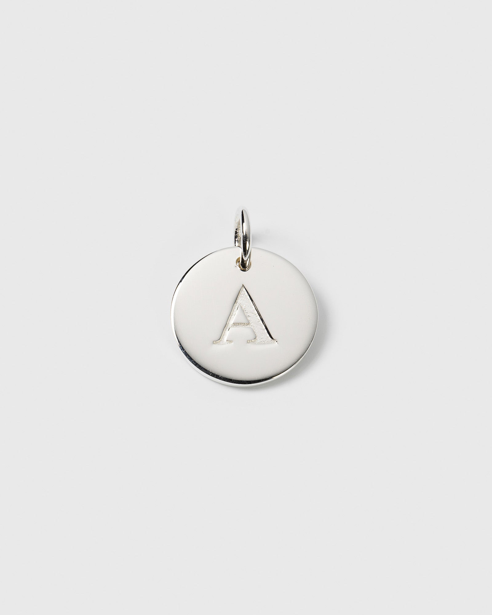 A product shot of the Beloved Big Letter Silver pendant, featuring a round silver charm with the letter 'A' engraved in the center.