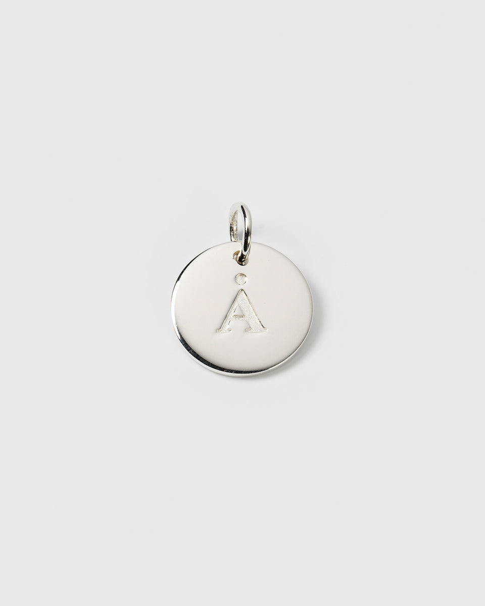 A product shot of the Beloved Big Letter charm in silver, a circular pendant engraved with the letter 'Å'.