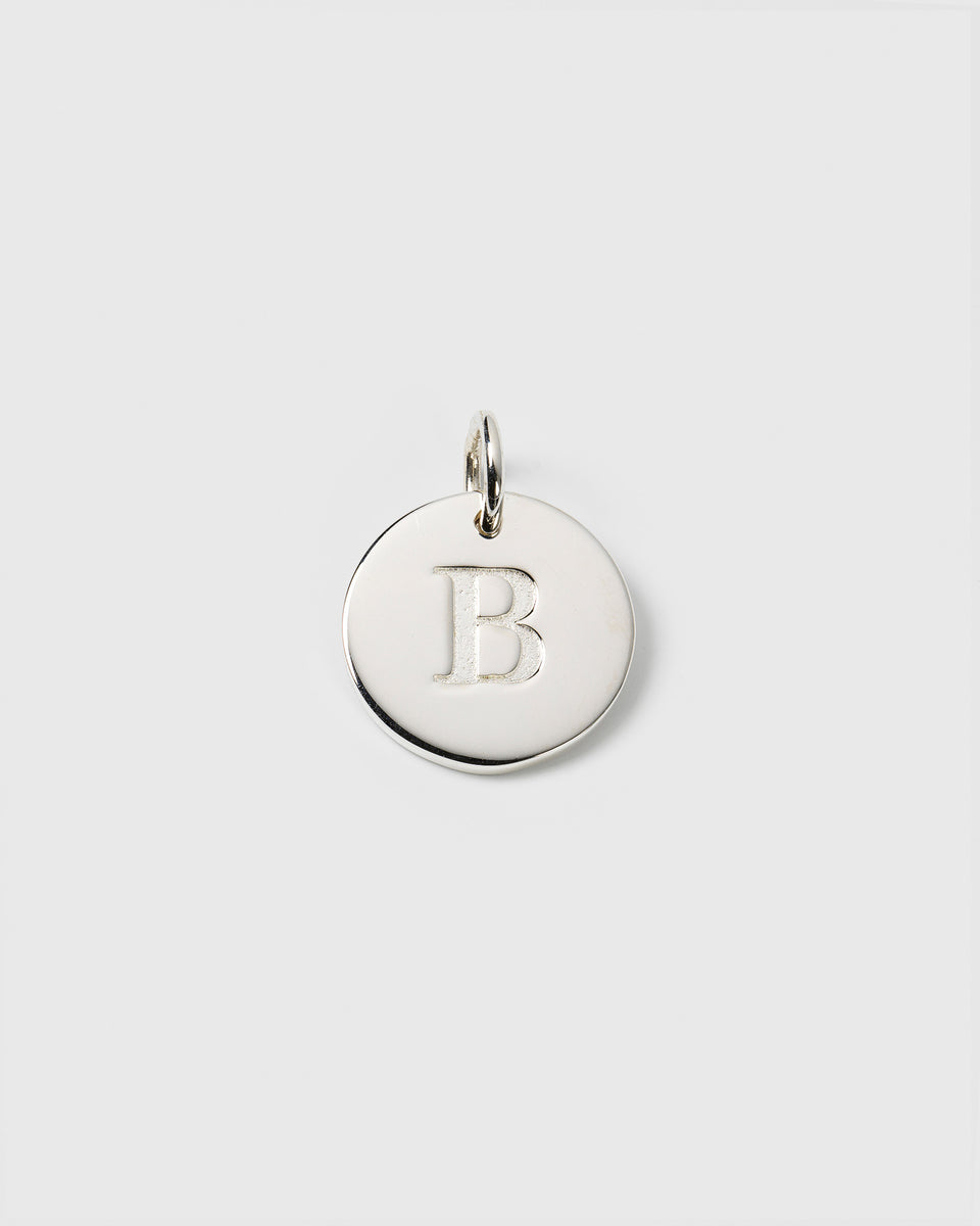 A product shot of the Beloved Big Letter Silver pendant, showing the circular silver charm with the initial 'B' engraved in the center.
