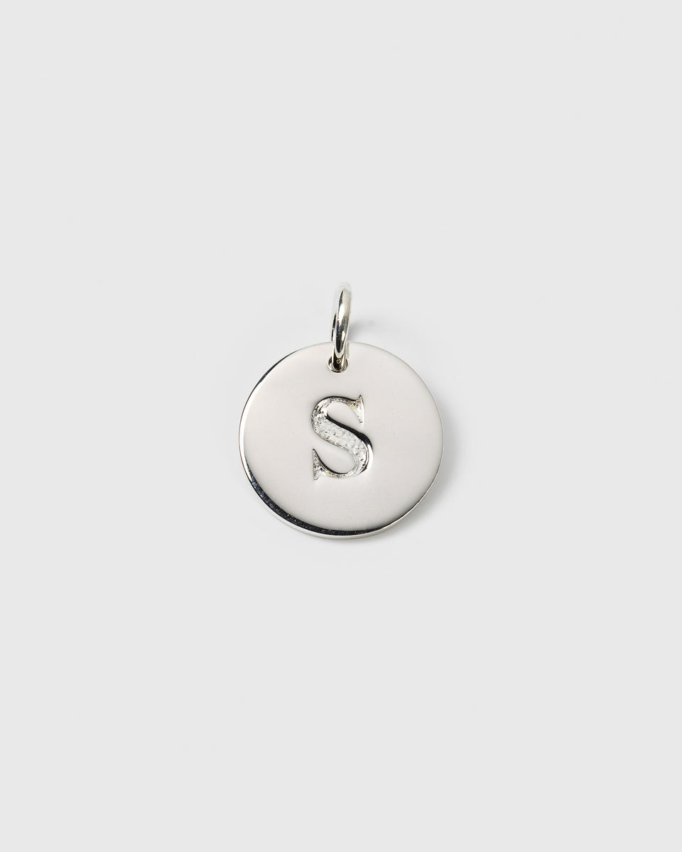 A product shot of the Beloved Big Letter Silver pendant, featuring the letter 'S' on a round, polished sterling silver charm.