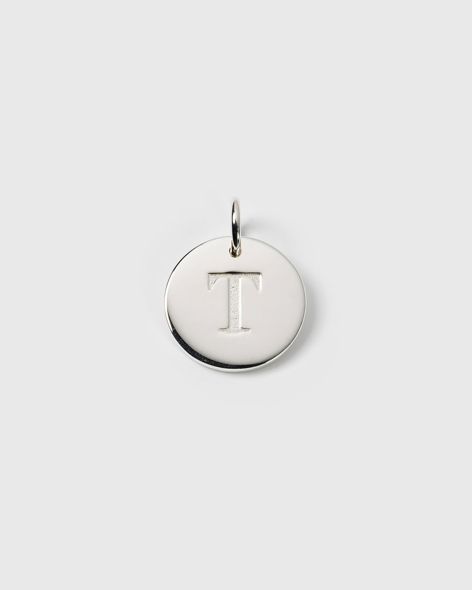A product shot of the Beloved Big Letter charm in silver, featuring the letter 'T' engraved on a circular pendant.