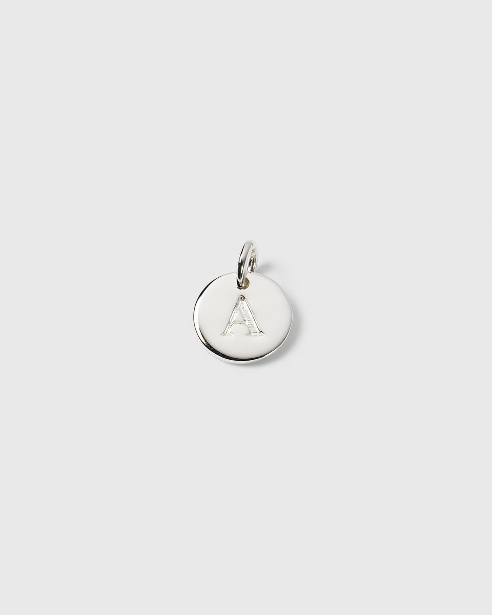 A product shot of the Beloved Mini Letter Silver pendant, featuring a small round charm with the letter 'A' engraved on it.