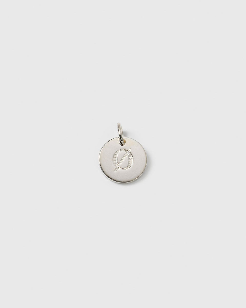 A product shot of the Beloved Mini Letter charm in silver, featuring the letter 'Ø' engraved on a small, round pendant.