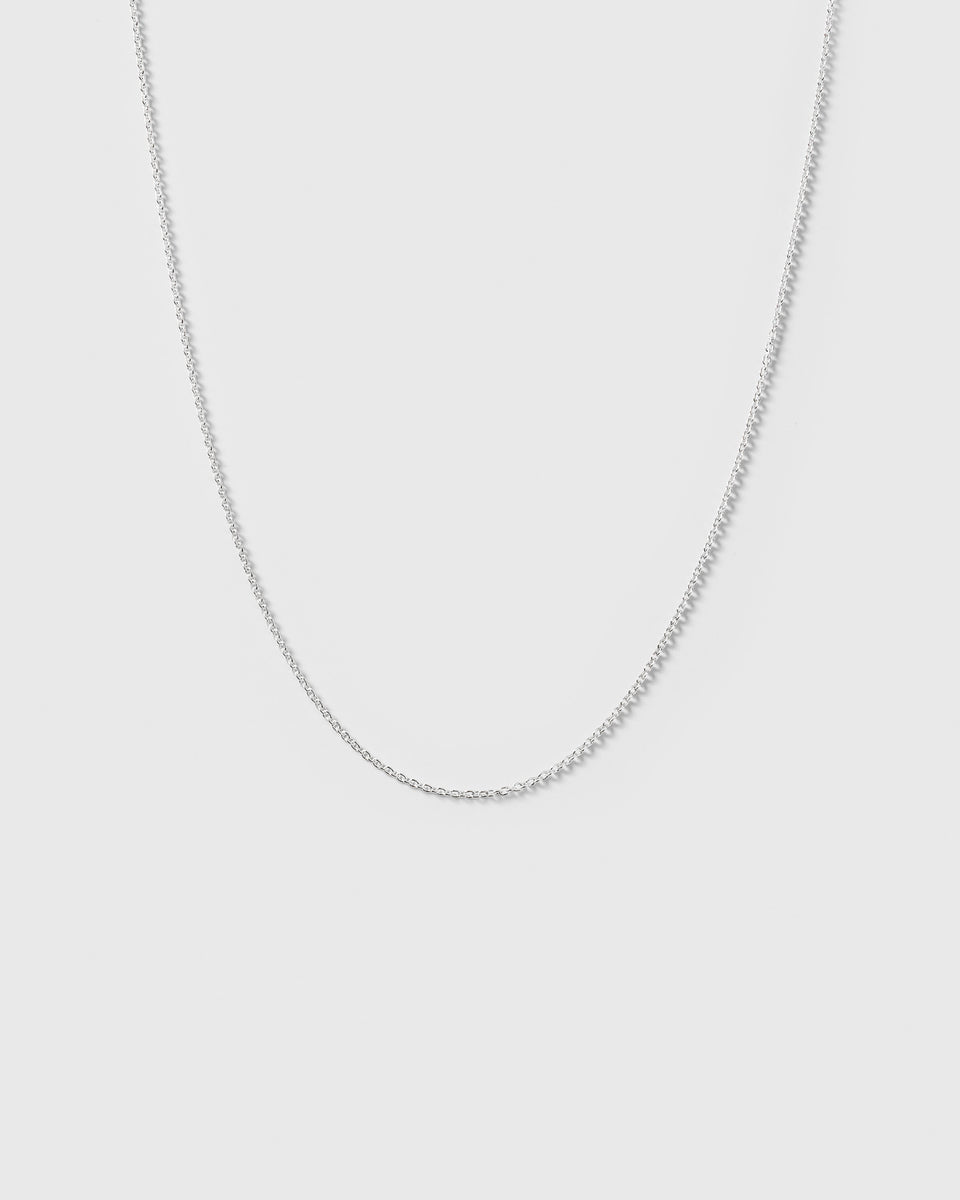 A product shot of the Beloved Baby Chain in silver, a simple and fine anchor chain necklace.