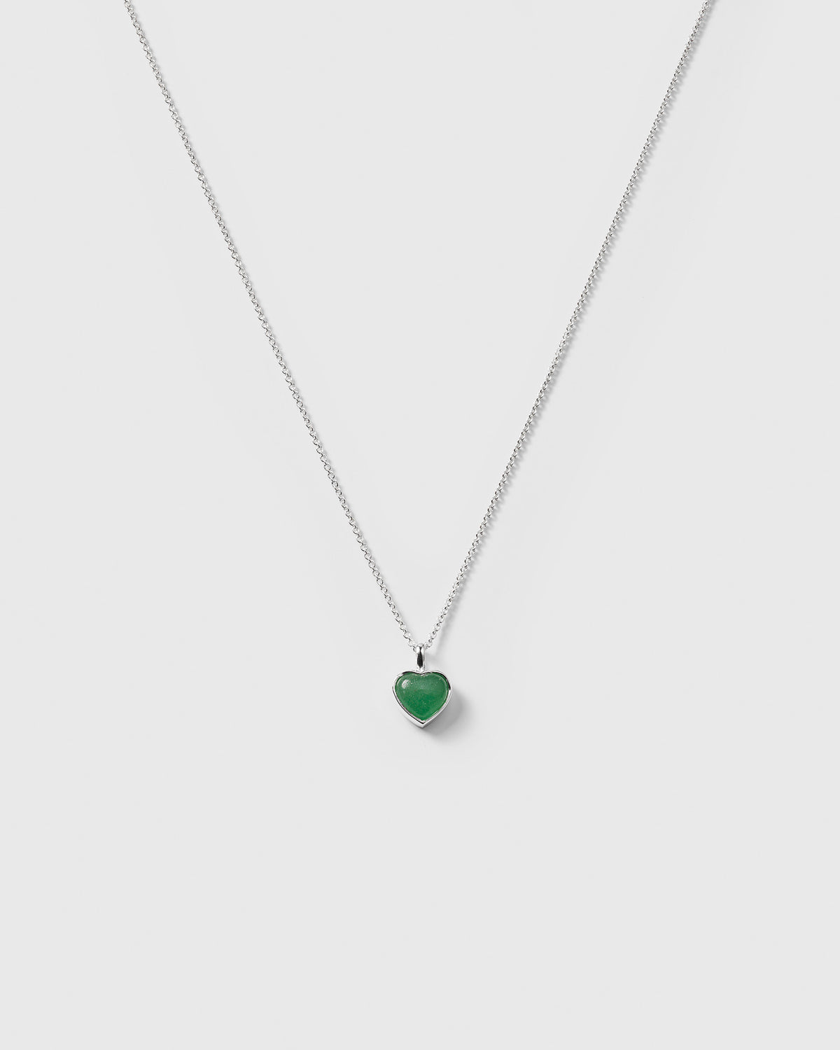 The La La Love Necklace in recycled sterling silver, featuring a delicate chain and a heart-shaped green jade pendant.