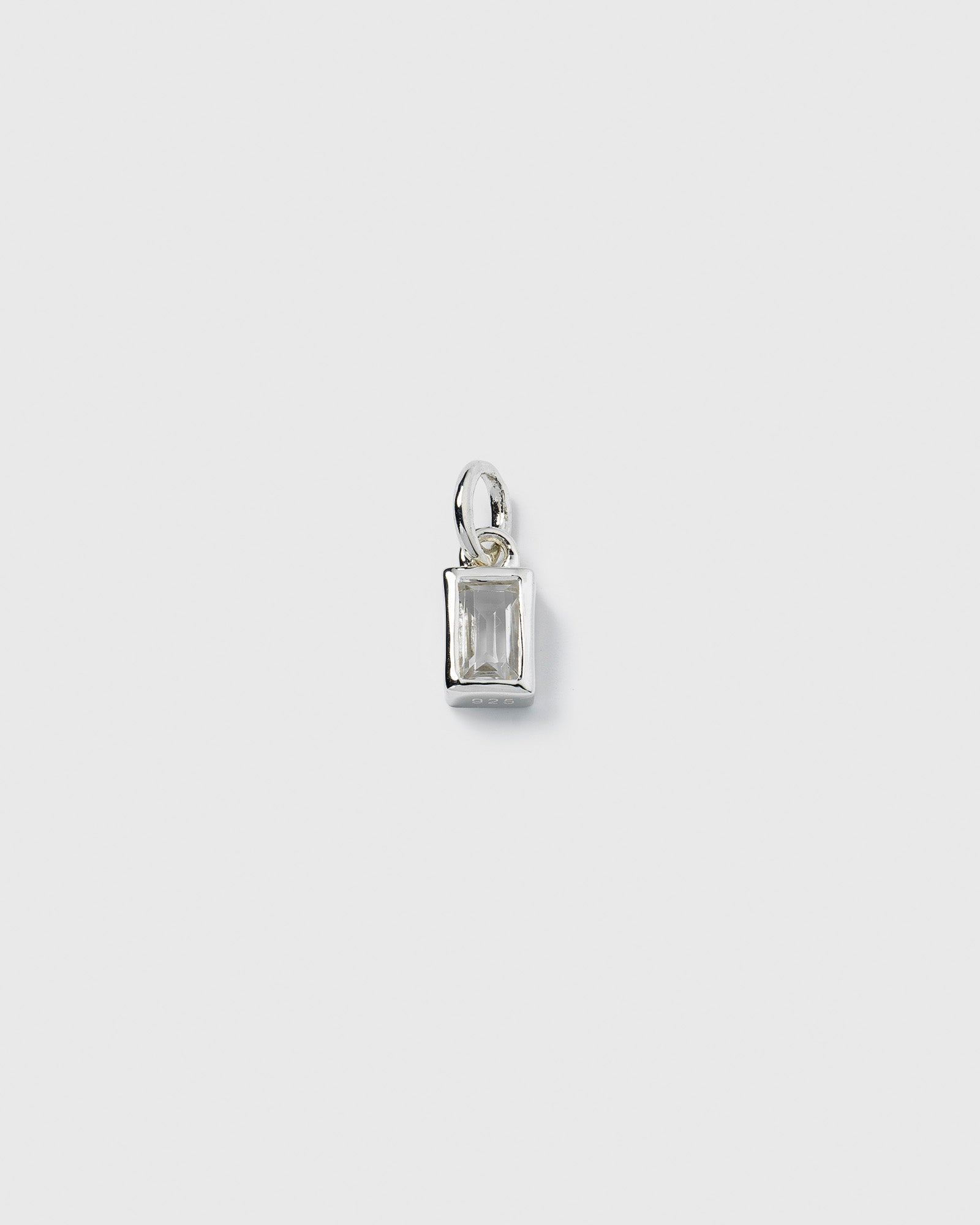 A product shot of the Beloved Squared Pendant in silver, featuring a rectangular clear crystal set in a simple, polished silver frame.