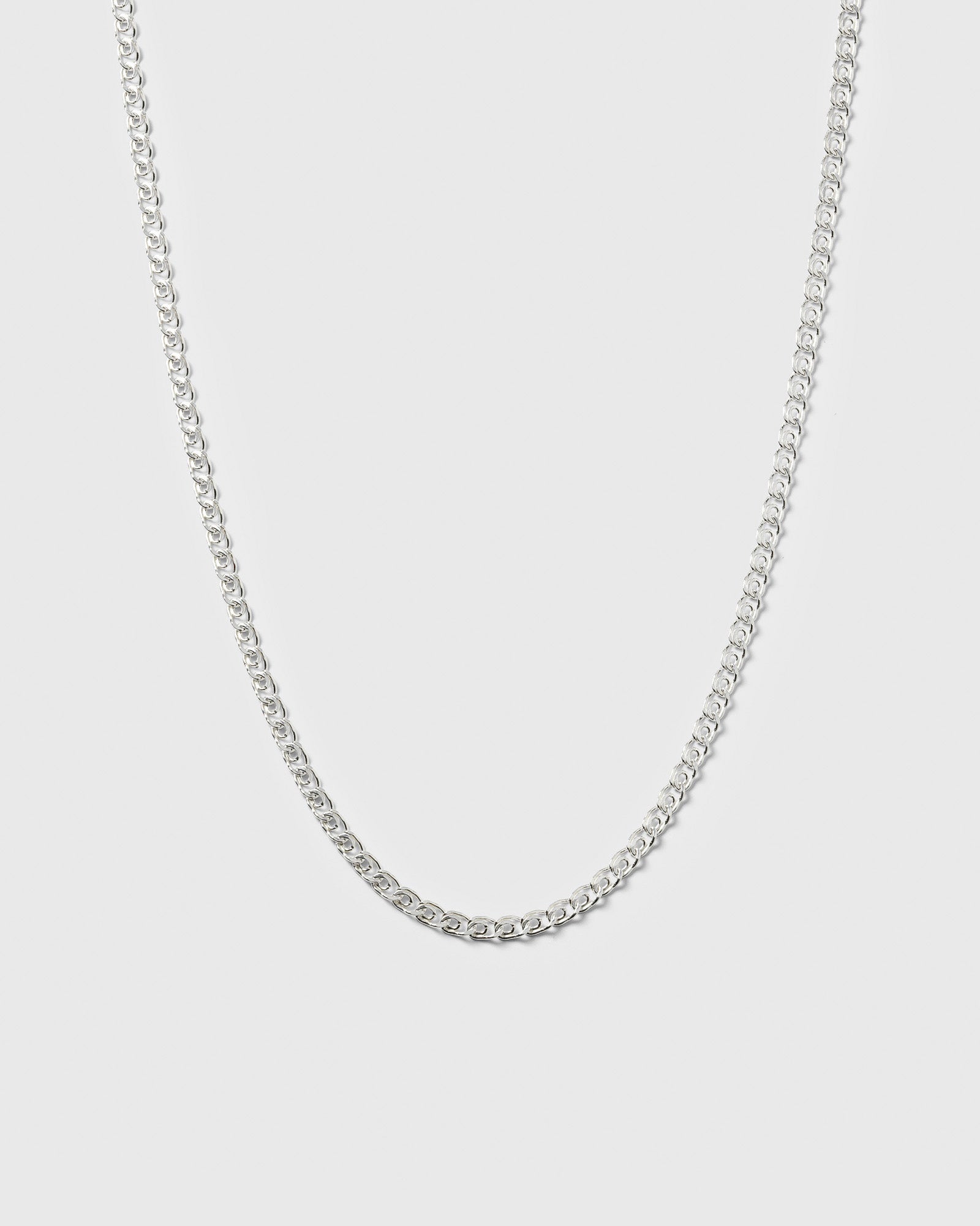 A product shot of the Sheer Love Necklace in silver, displayed in a U-shape to highlight its uniquely patterned links.