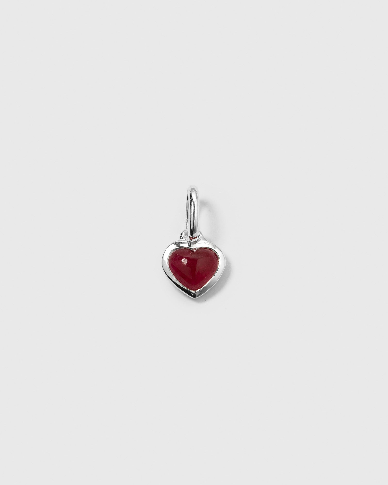 A product shot of the Beloved Heart Pendant in silver, featuring a heart-shaped pink quartz stone.