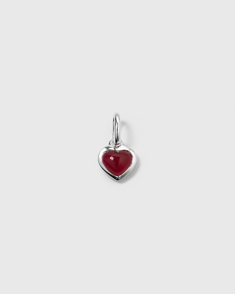 A product shot of the Beloved Heart Pendant in silver, featuring a heart-shaped pink quartz stone.