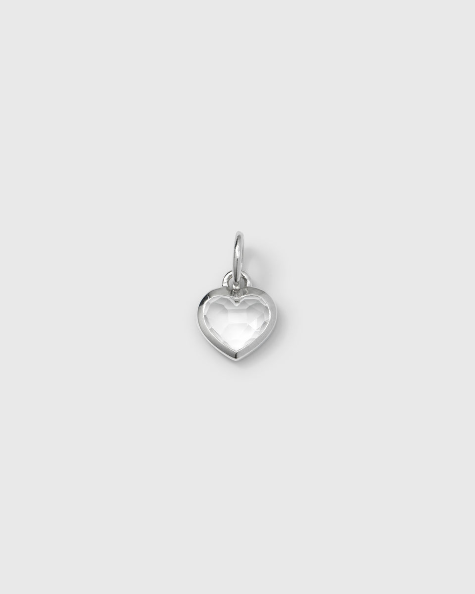 A product shot of the Beloved Heart Pendant in silver, featuring a heart-shaped design with a faceted crystal set within a silver frame.