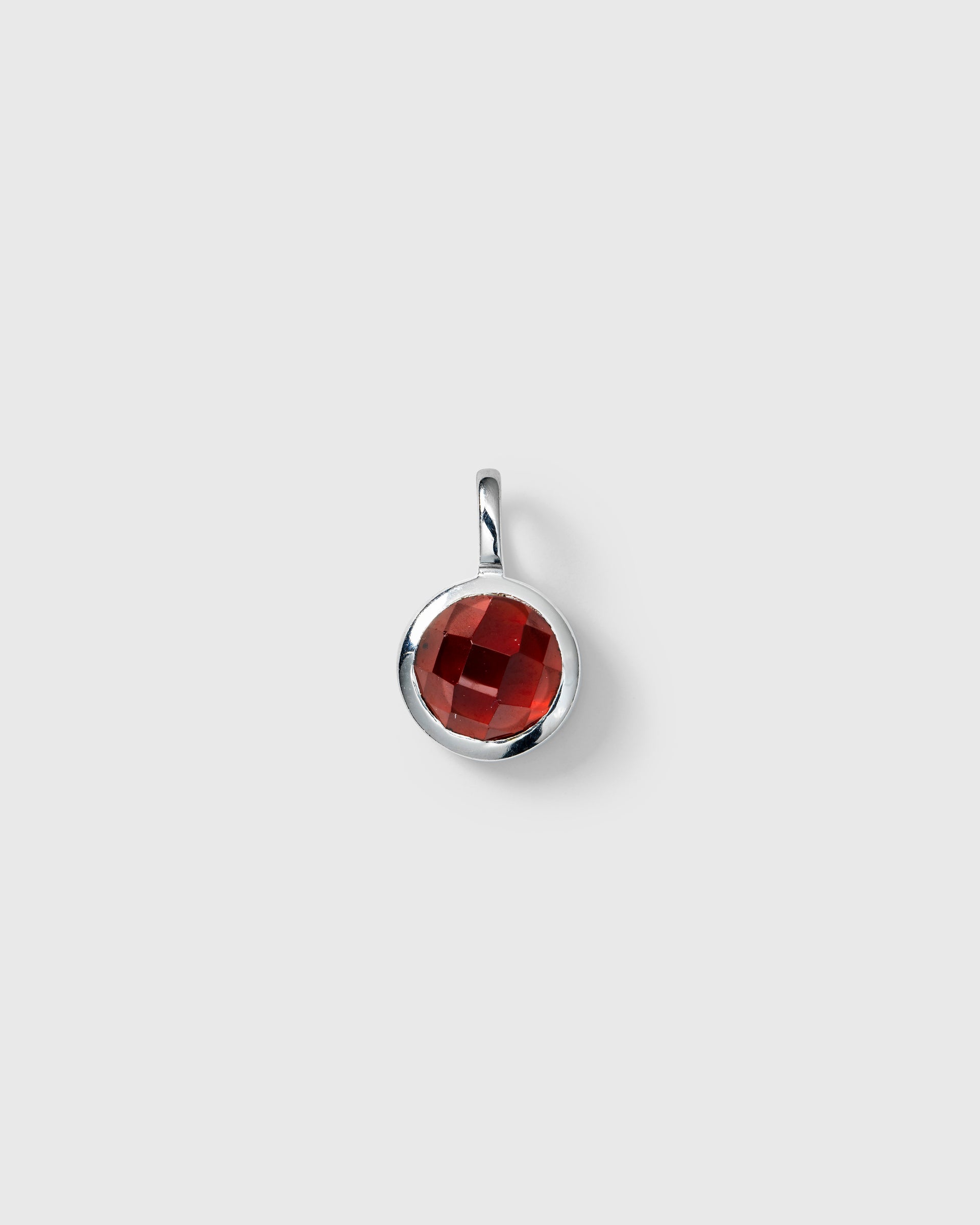 Gold chain with January birthstone red garnet and letter pendants.