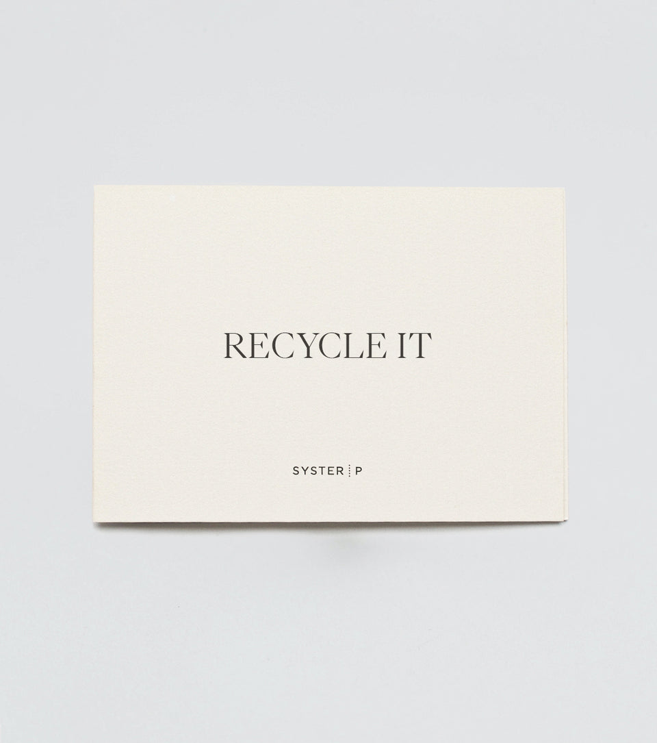 A product shot of the Syster P 'Recycle It' coupon, displayed as a cream-colored card with black text.