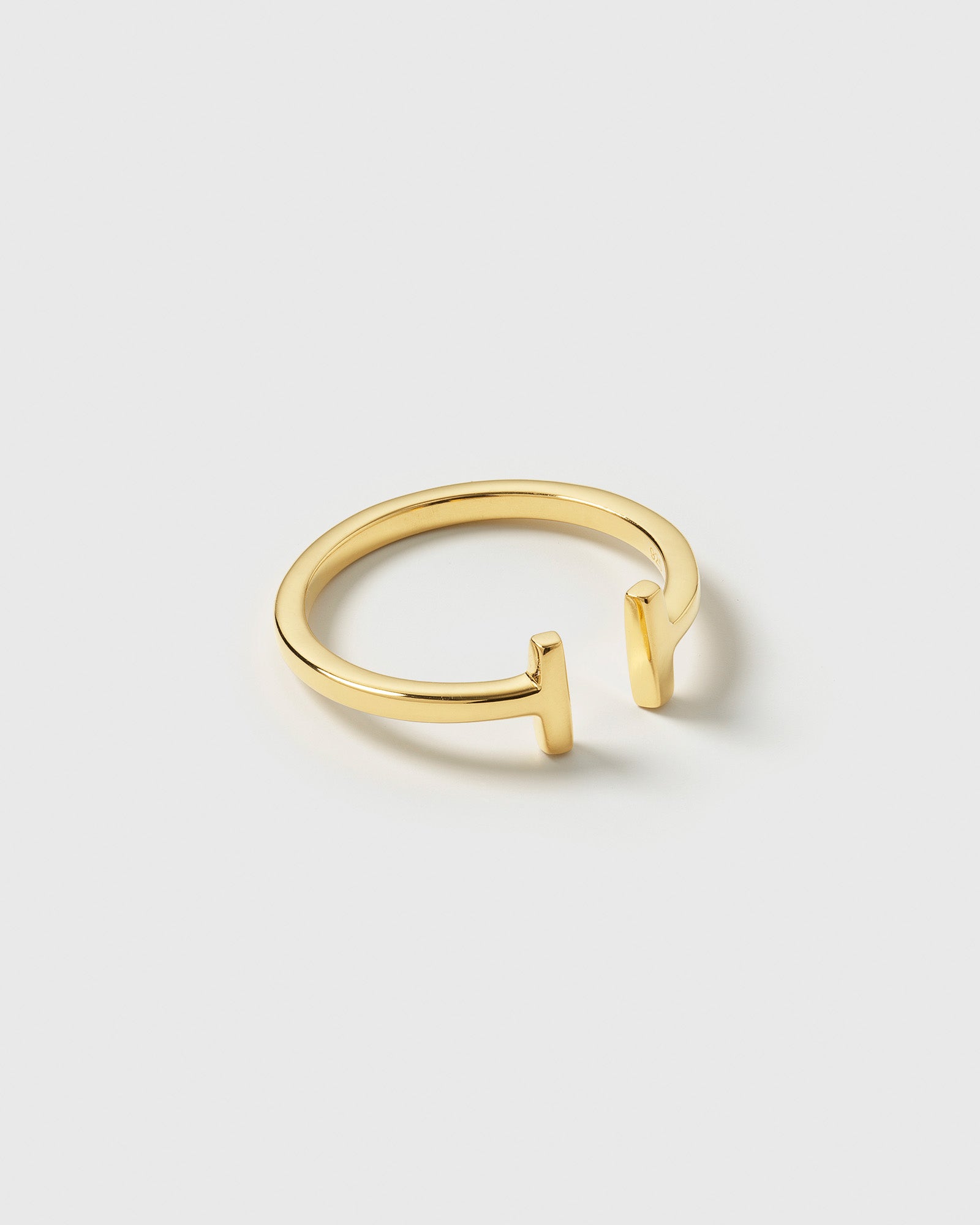 A product shot of the Strict Bar Ring Gold, featuring its open, adjustable design with two vertical bar-shaped ends.
