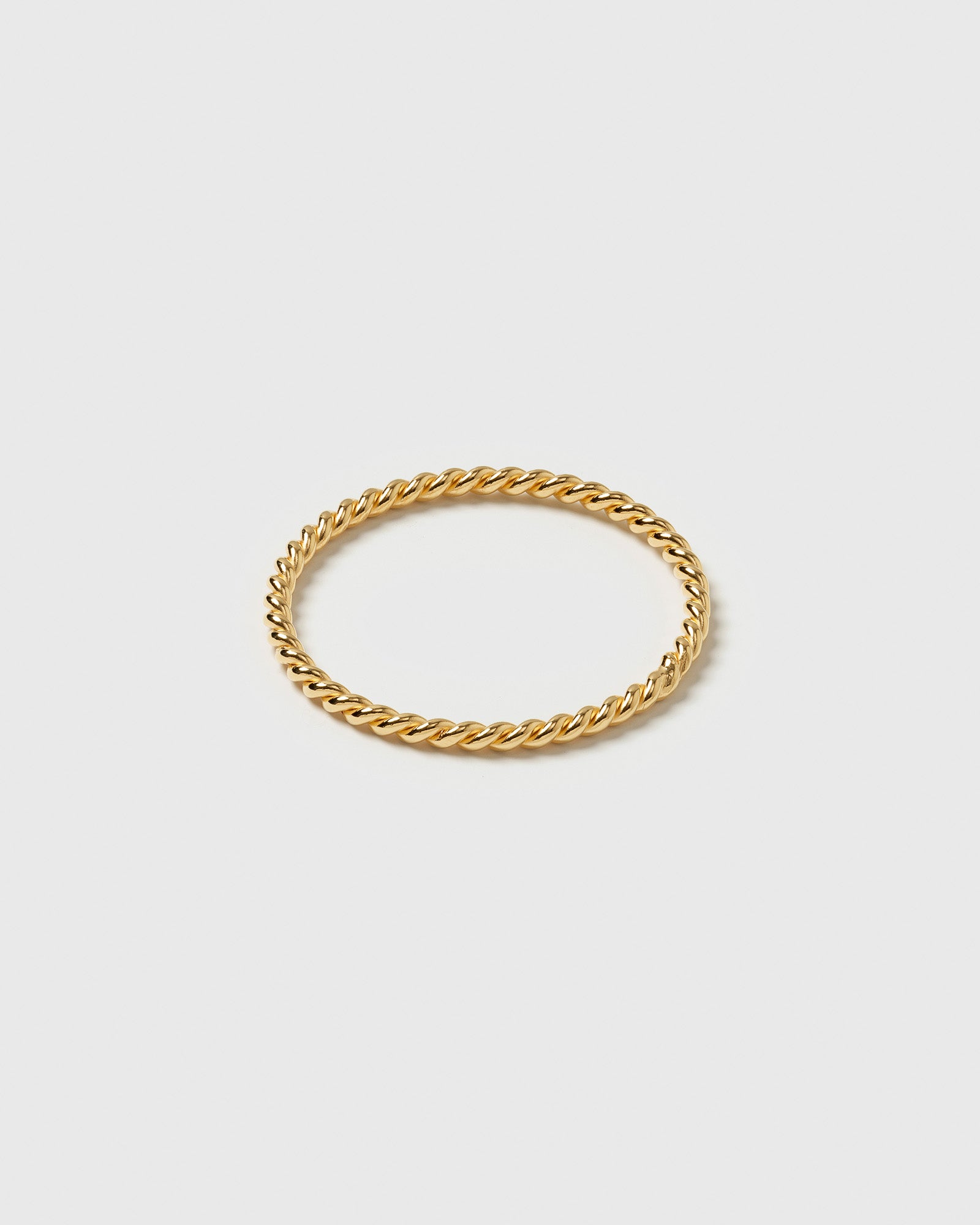 A product shot of the Tiny Twisted Ring Gold, highlighting its delicate, twisted band.